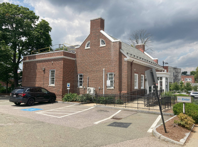 A brick building with a car parked in front of it.