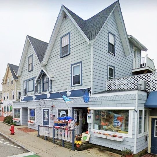 A large gray building with a blue awning on the side of it
