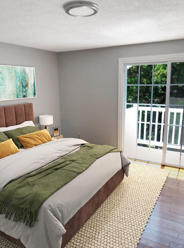 A bedroom with a large bed and a sliding glass door