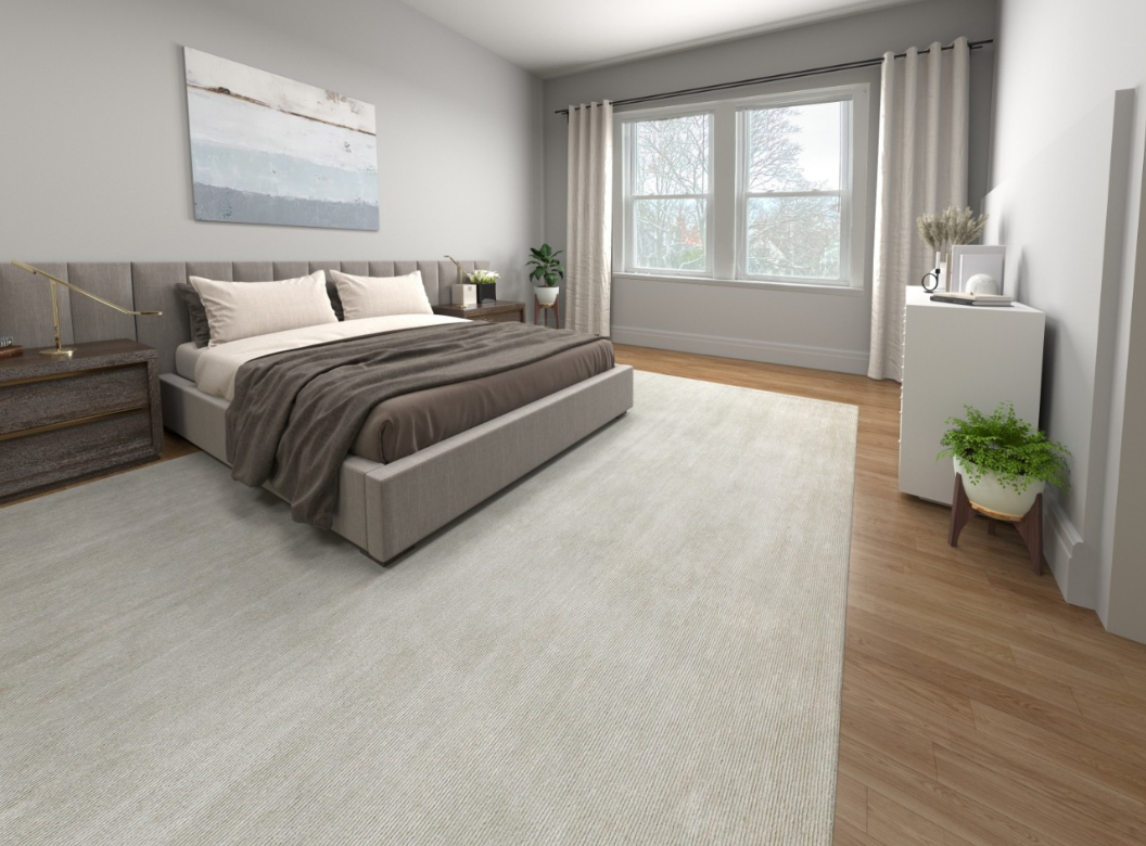 A bedroom with a large bed , two nightstands , two windows and a rug.