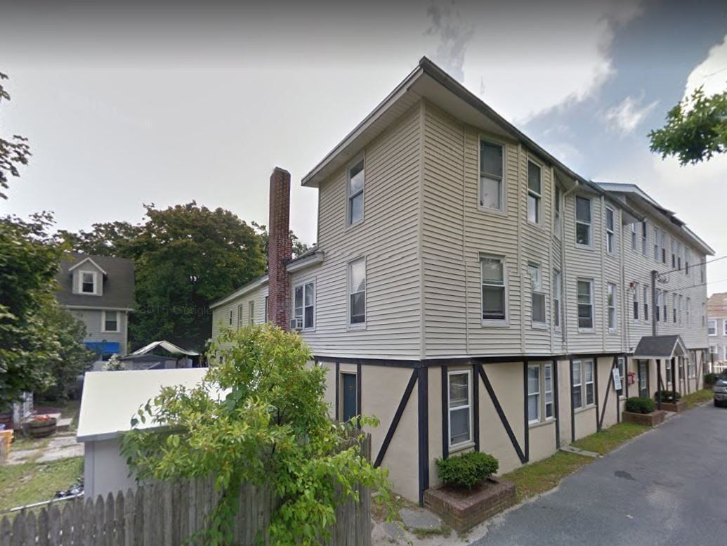 A large building with a chimney on the side of it