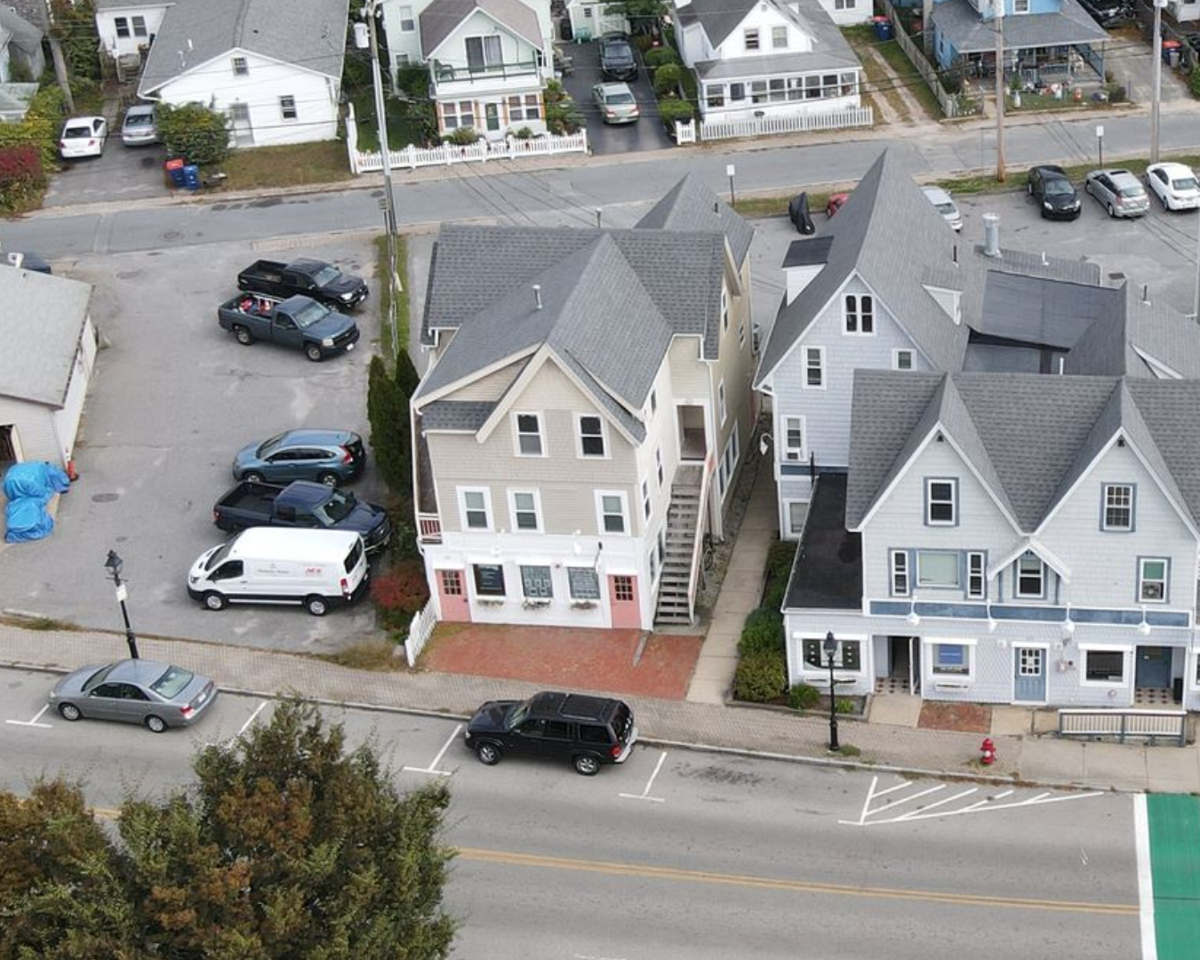 A large house with a store front on the side of it.
