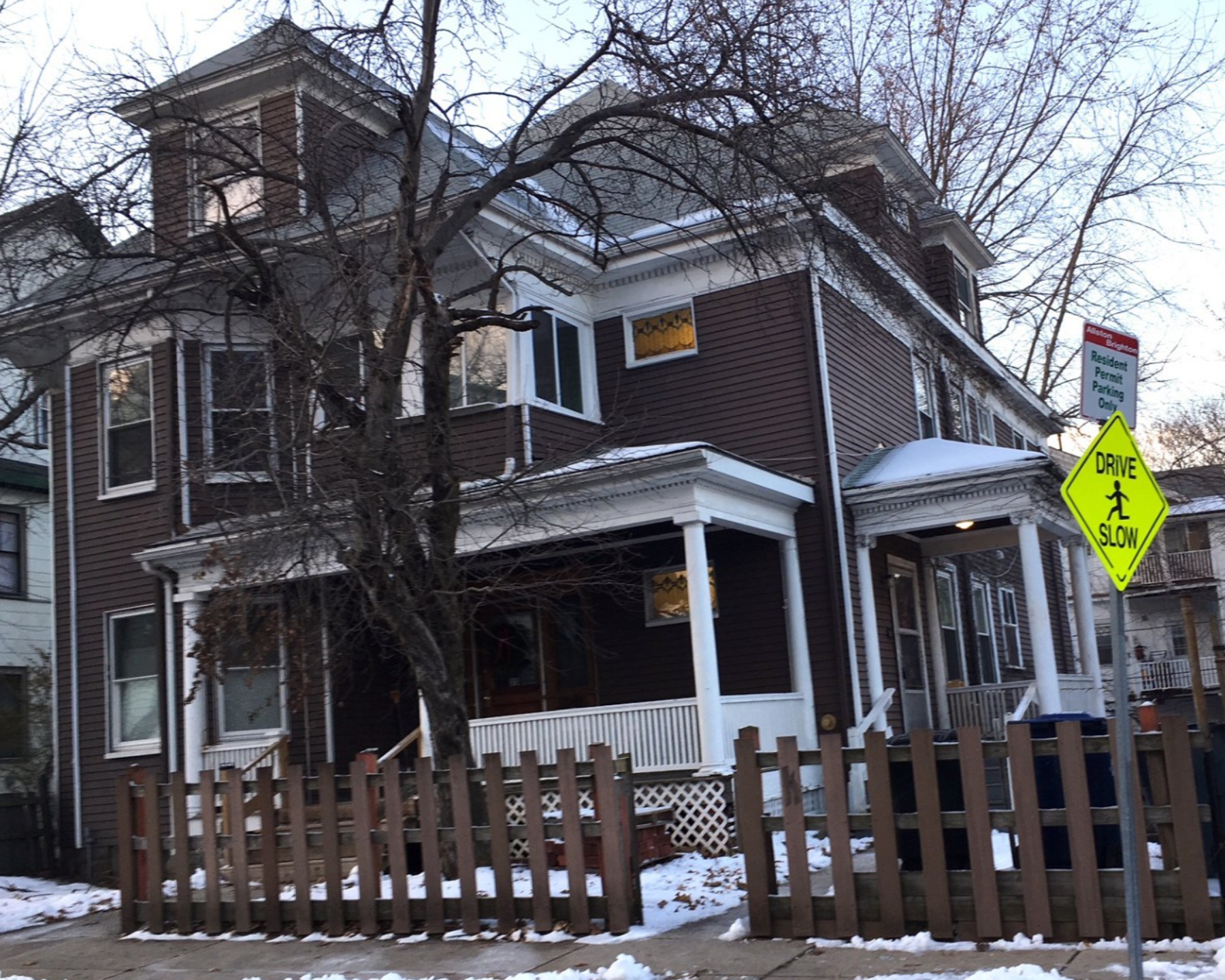 A house with a yellow sign that says no left turn