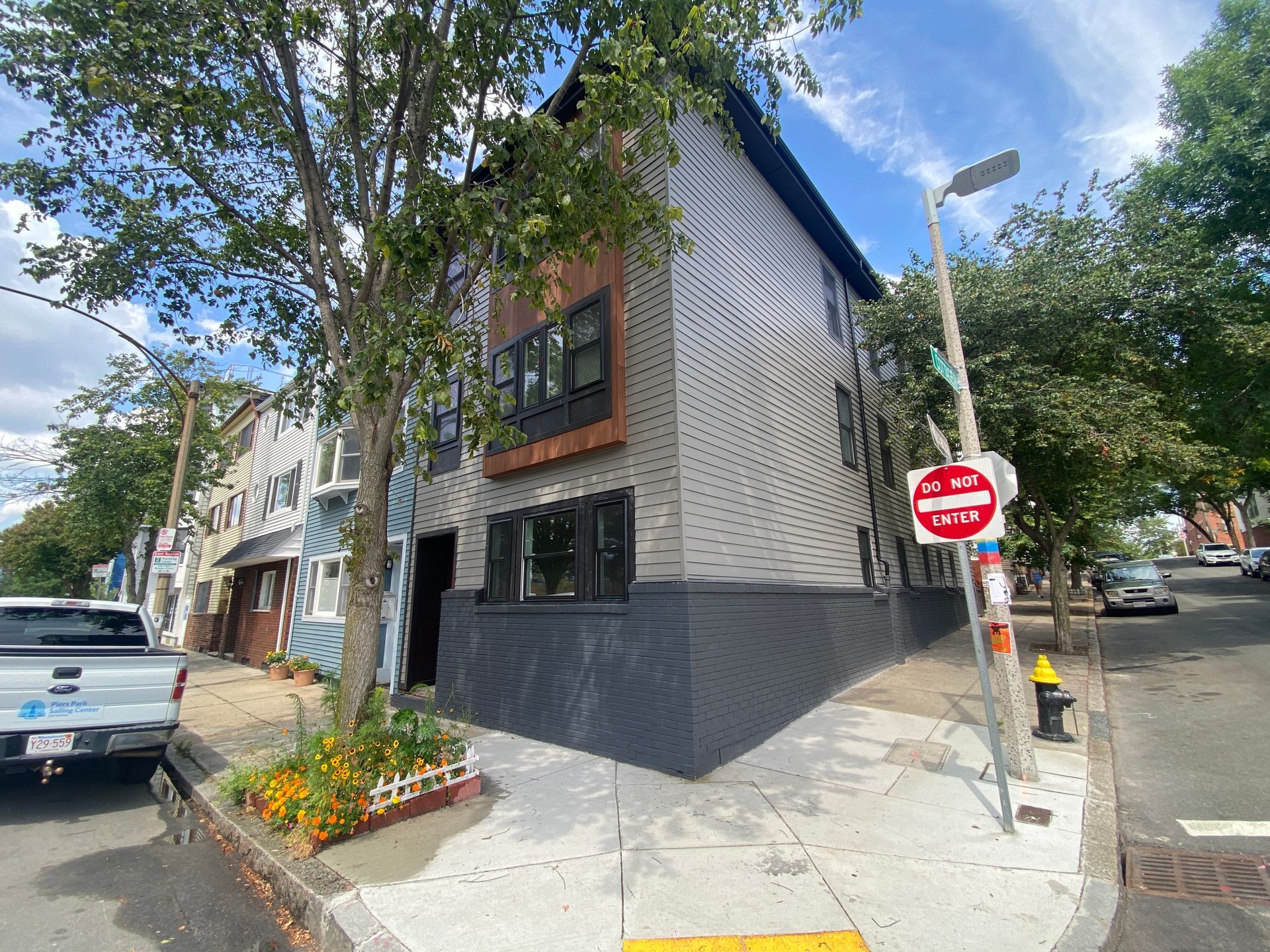 A building with a stop sign on the side of it is on the corner of a street.