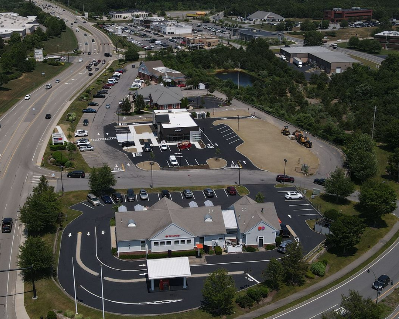 An aerial view of a highway and a parking lot