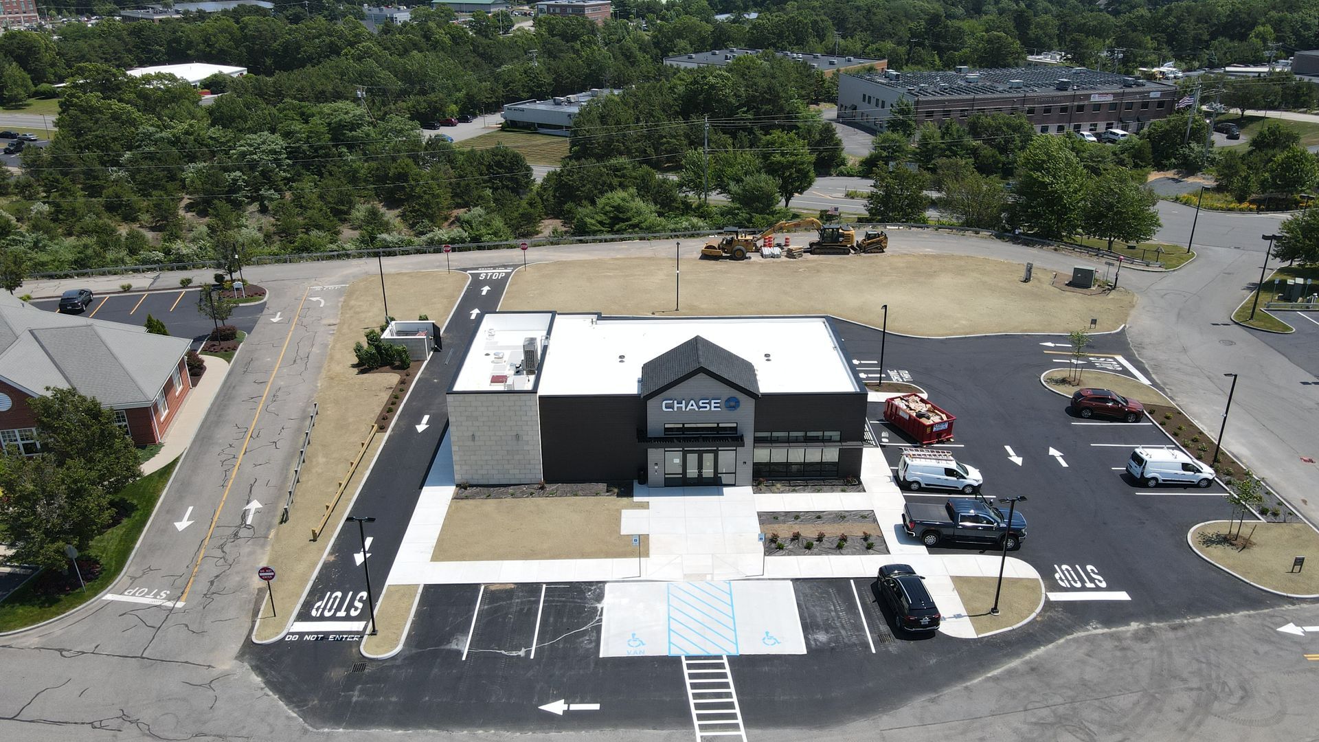 An aerial view of a building with a parking lot in front of it