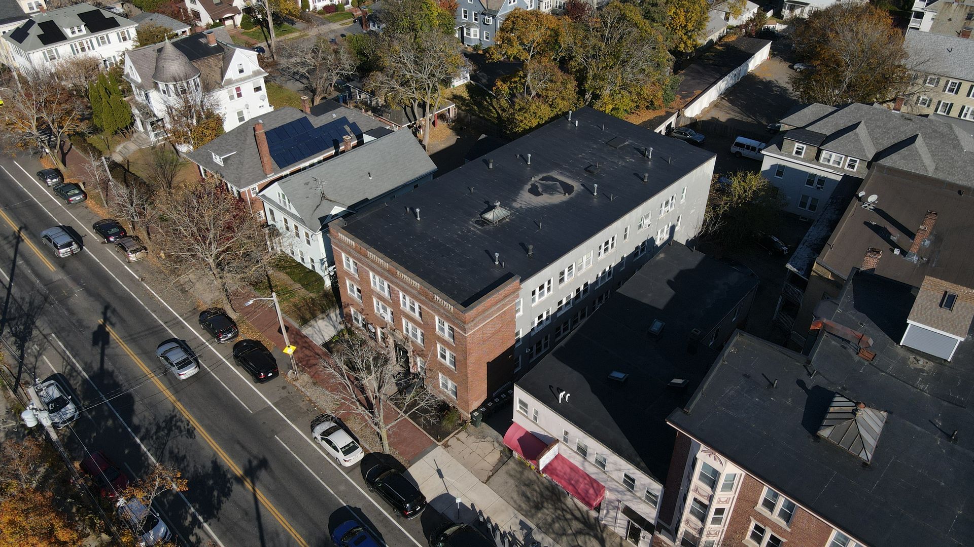 An aerial view of a residential area with a large building in the middle.