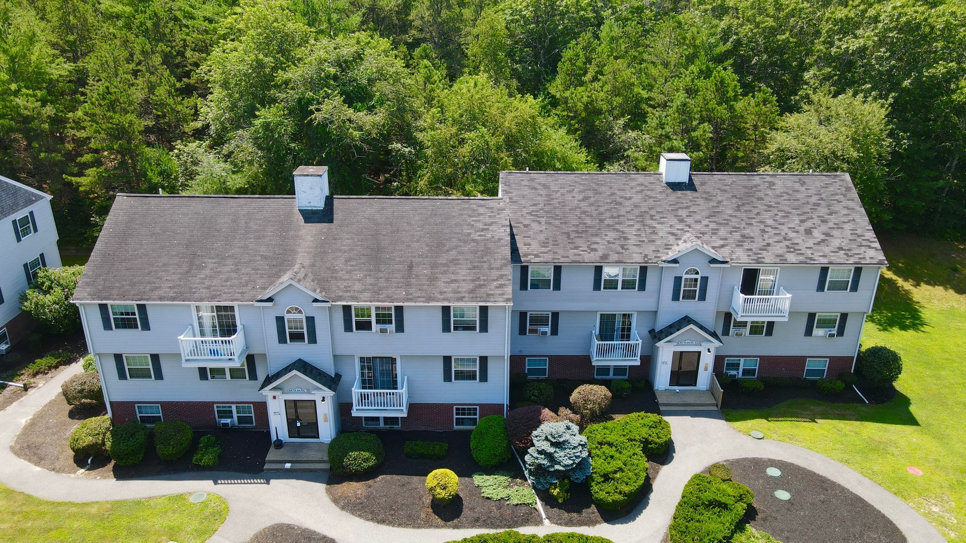 An aerial view of a house with a black roof