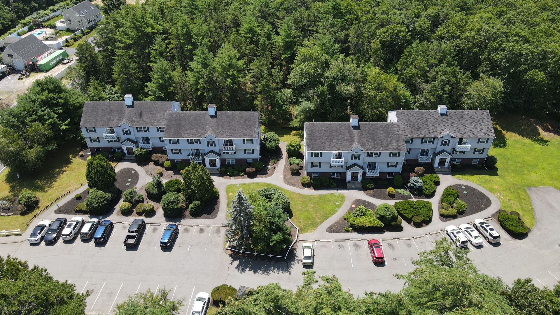 An aerial view of a building with cars parked in front of it