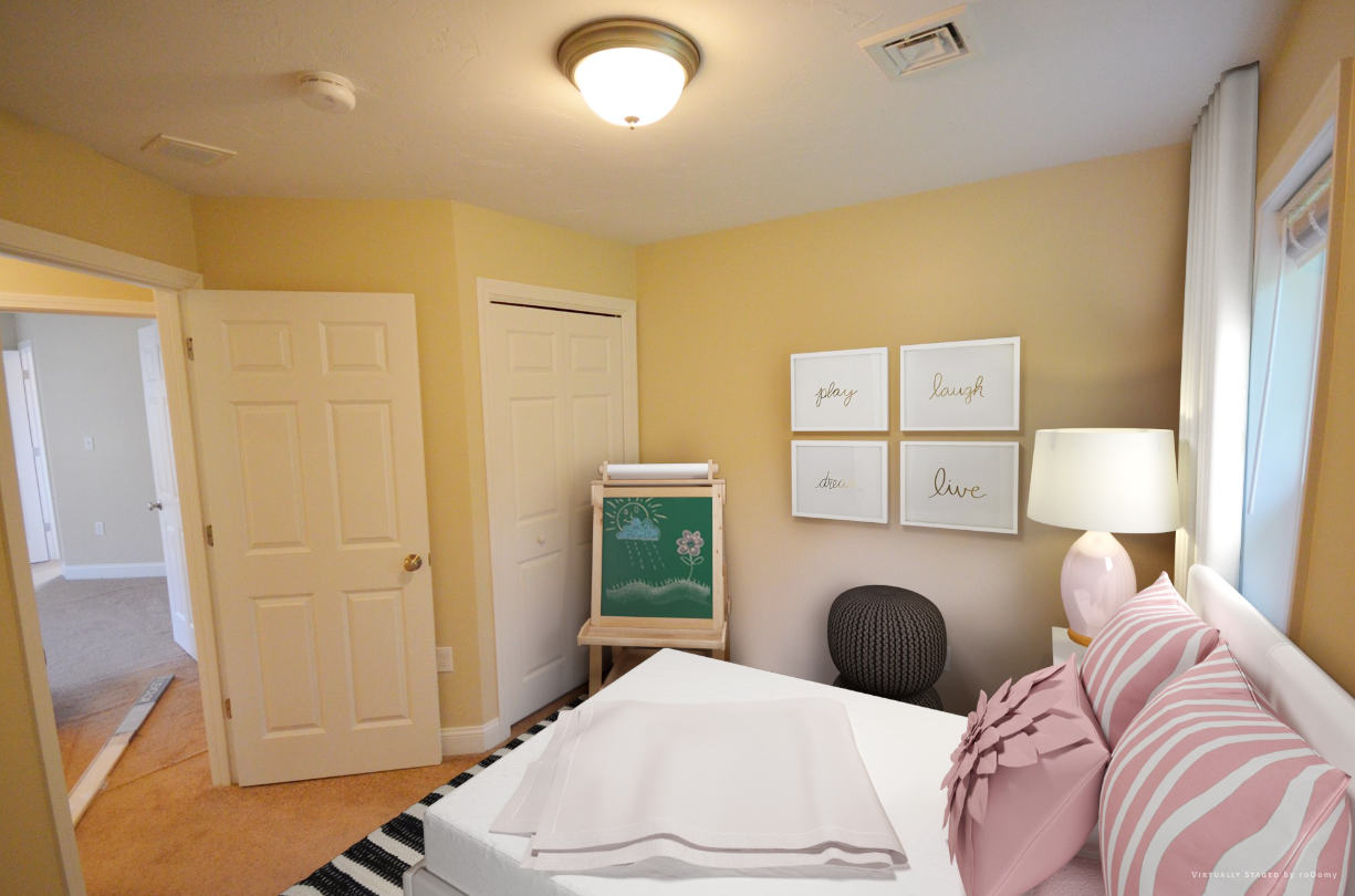 A bedroom with a bed and a chalkboard on the wall