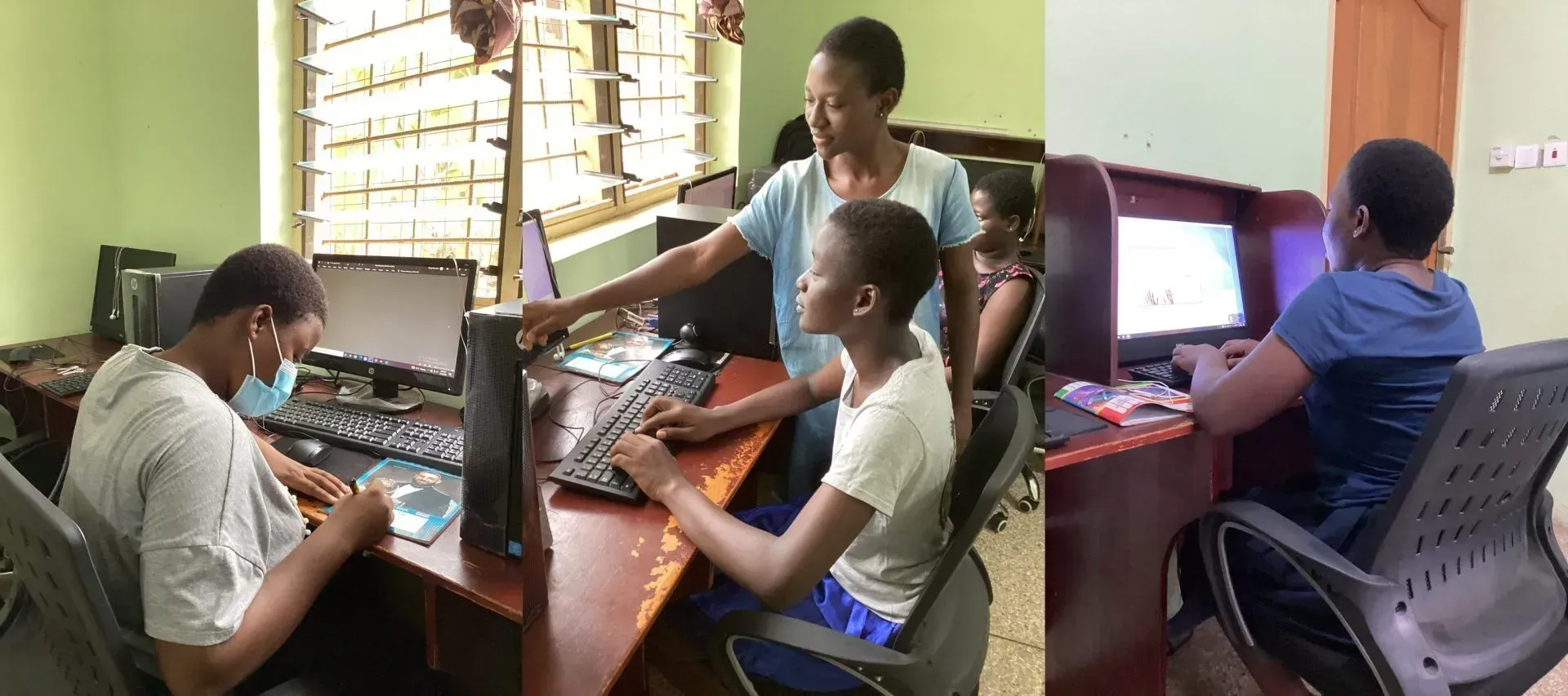 A group of people are sitting at desks in front of computers.