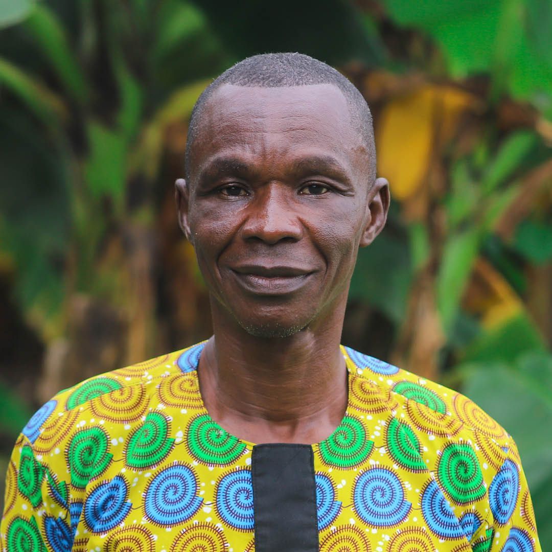 A man in a colorful shirt is smiling for the camera.