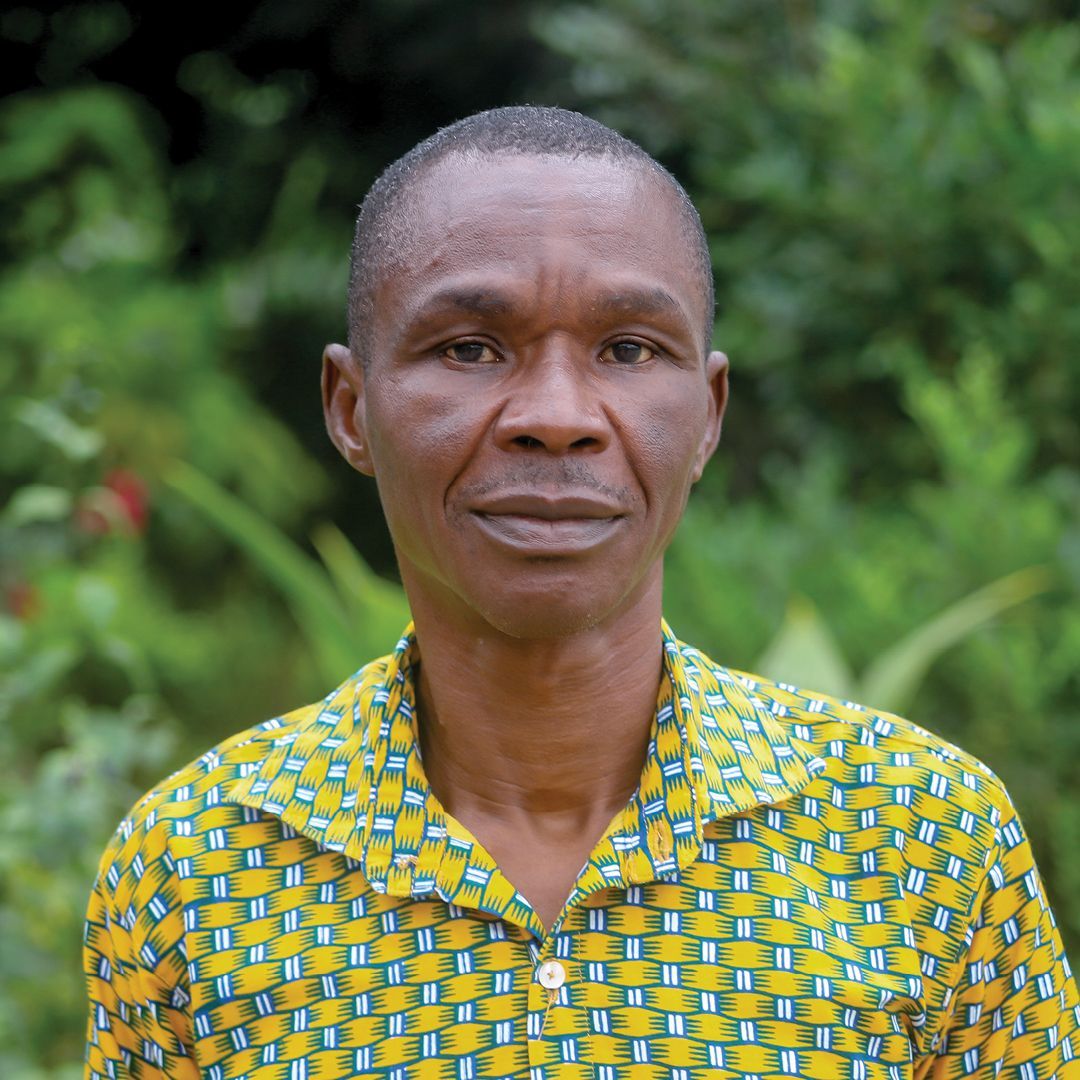 A man in a colorful shirt is smiling for the camera.