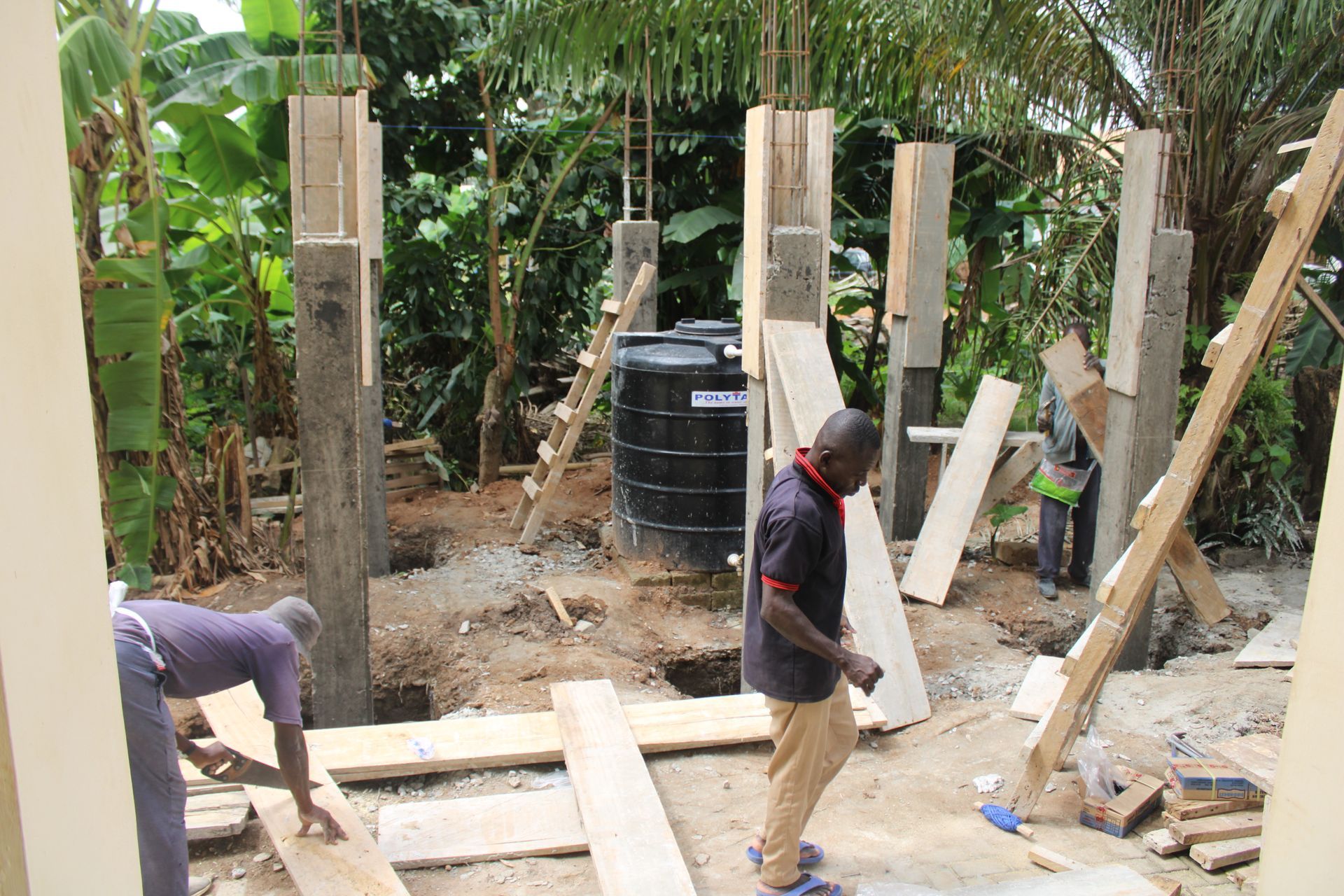 A construction site with a water tank in the background