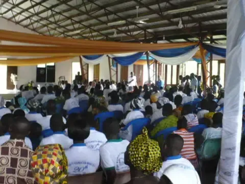 A large group of people are sitting in a large room