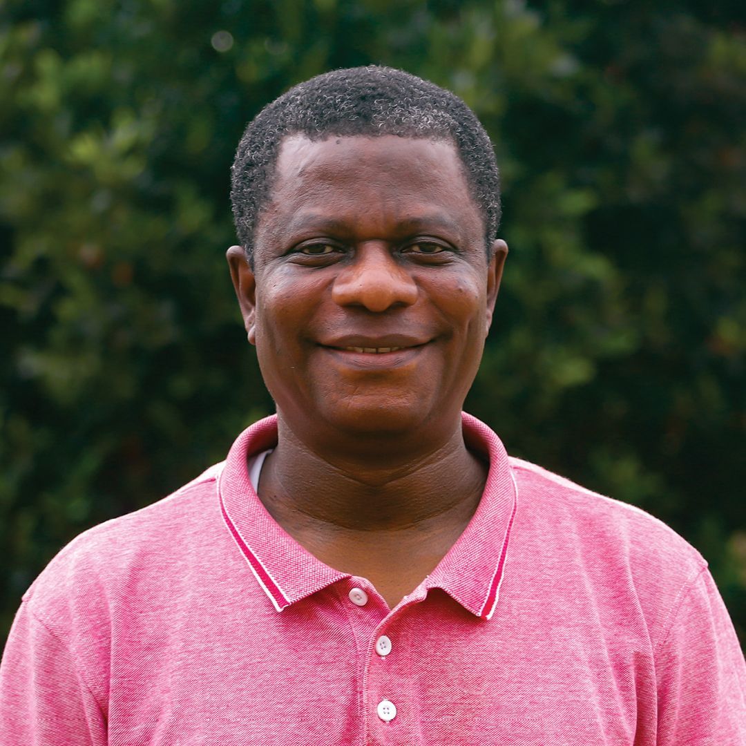 A man in a plaid shirt is smiling for the camera.