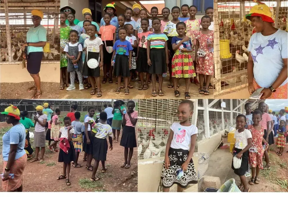 A group of children are standing next to each other in front of a building.