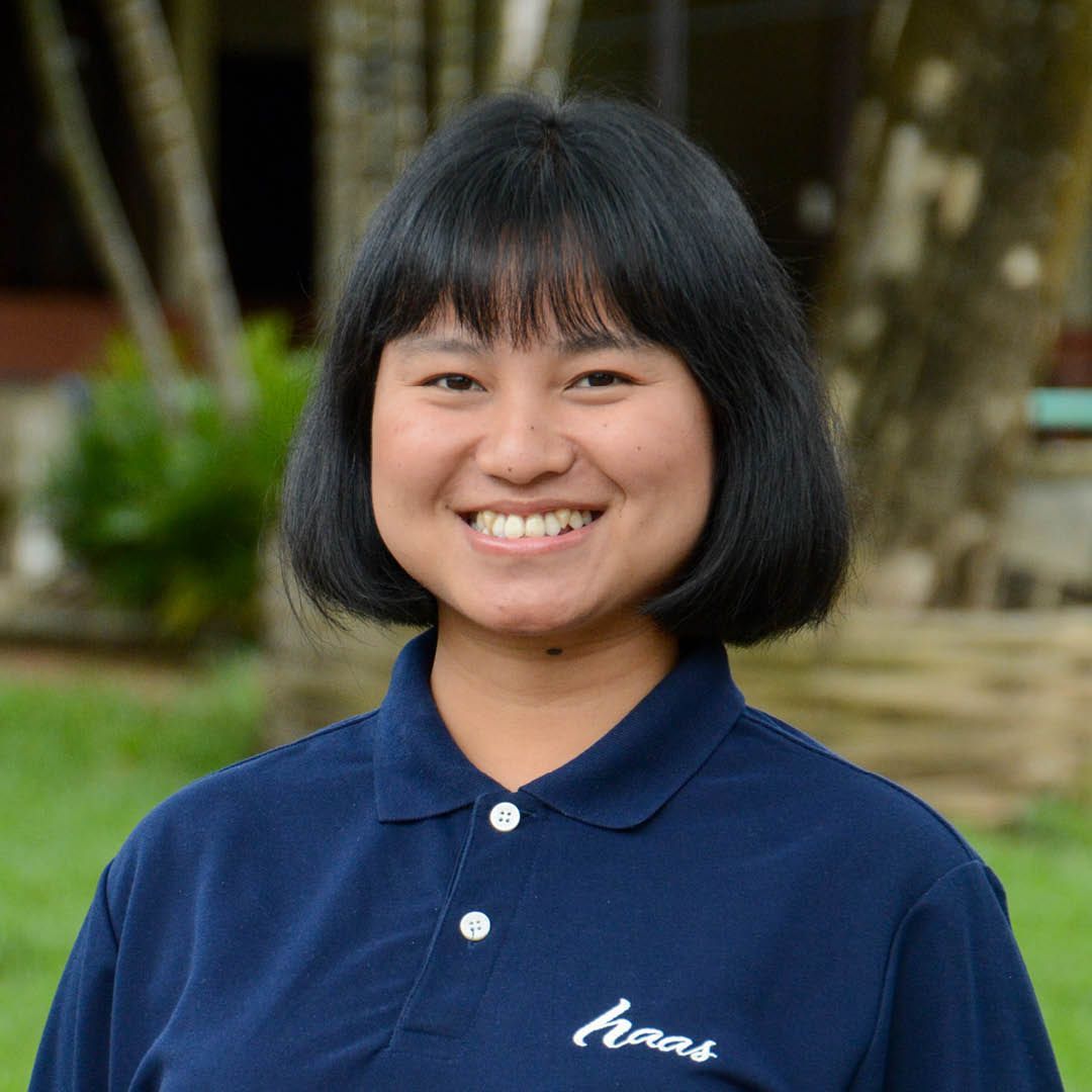 A woman wearing a blue shirt with the word ears on it