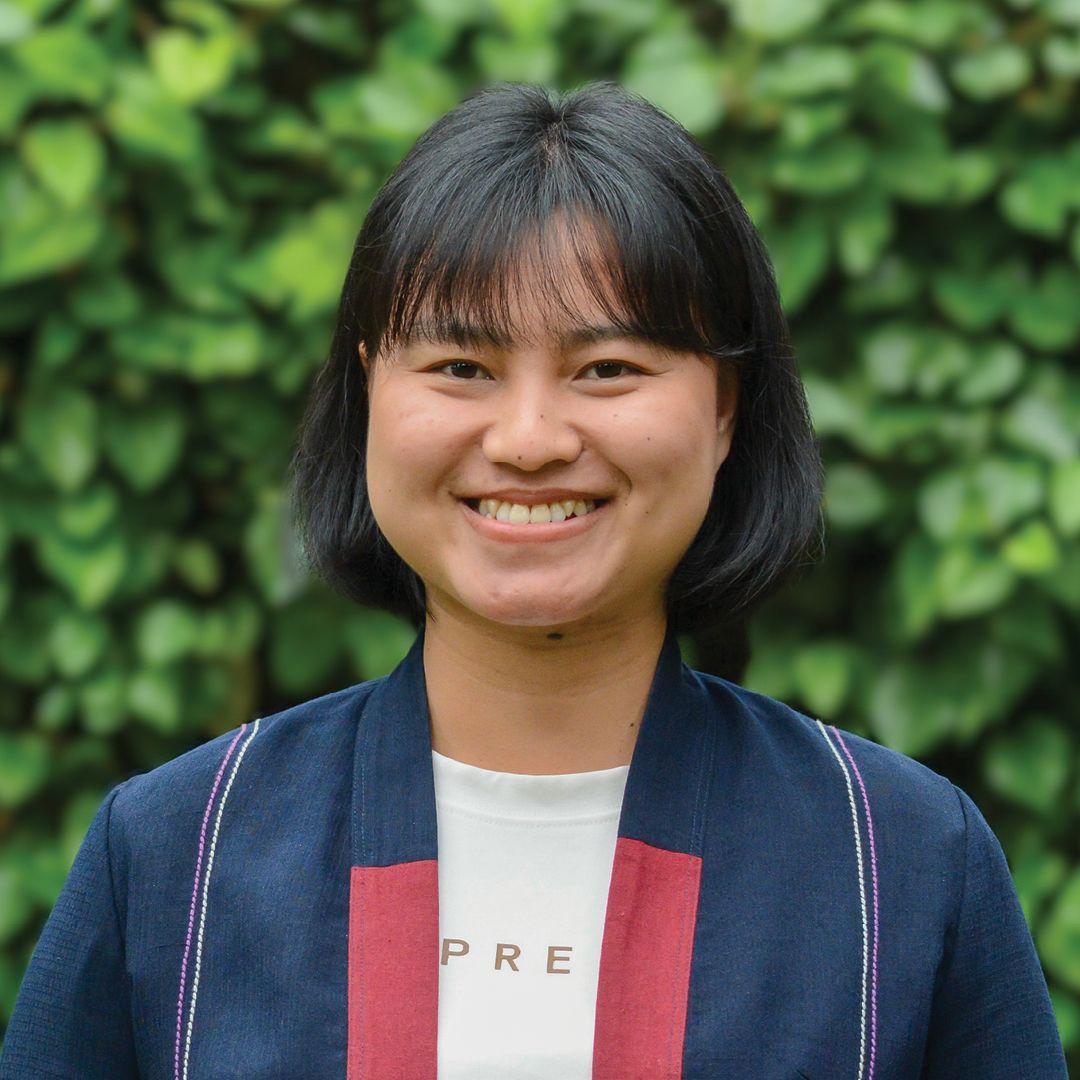 A woman wearing a blue shirt with the word ears on it