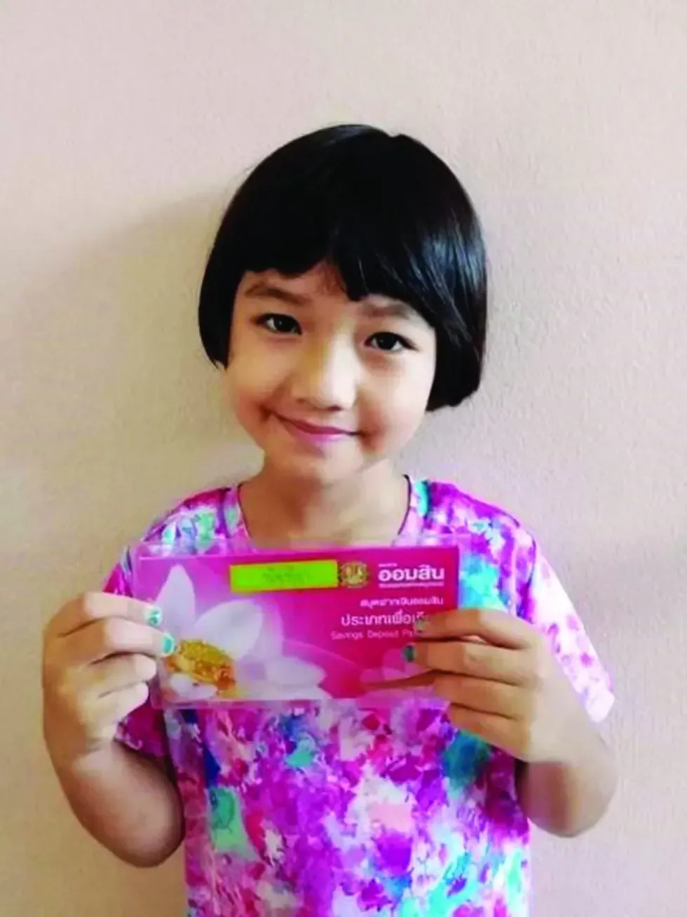 A little girl is holding a card that says ' dignity ' on it