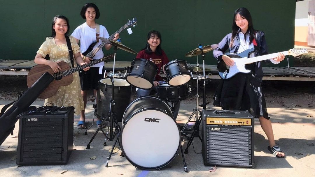 A group of people standing next to each other playing instruments.