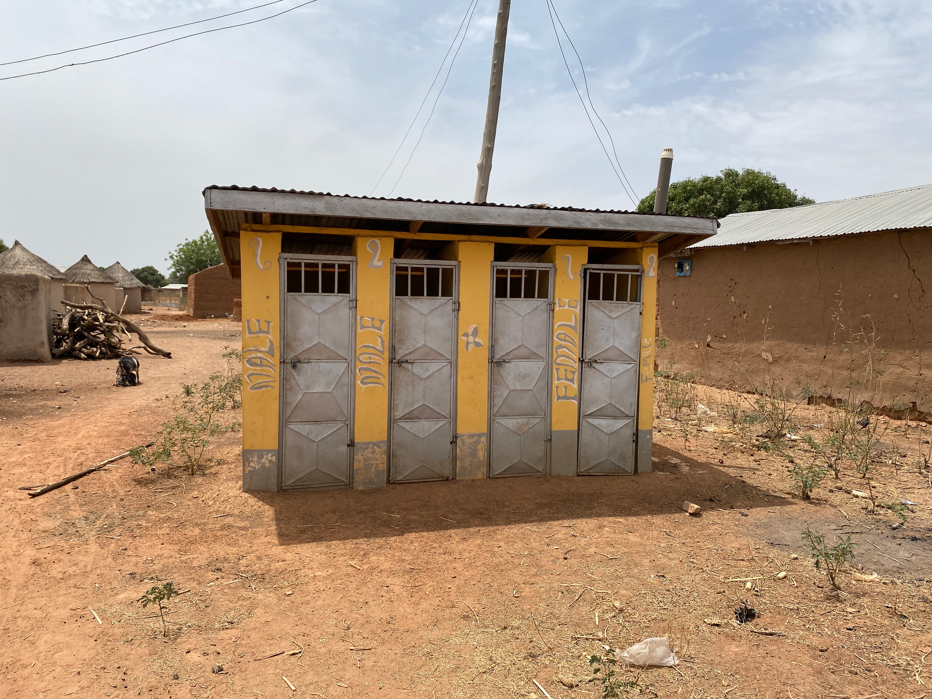 A row of toilets with one that says milk on it