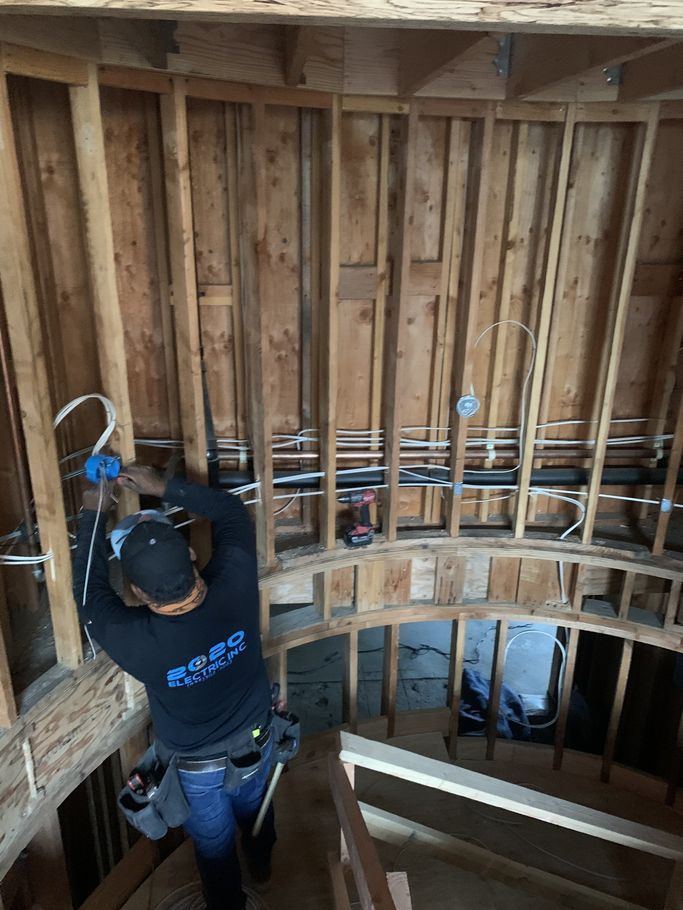 A man is working on the ceiling of a building.