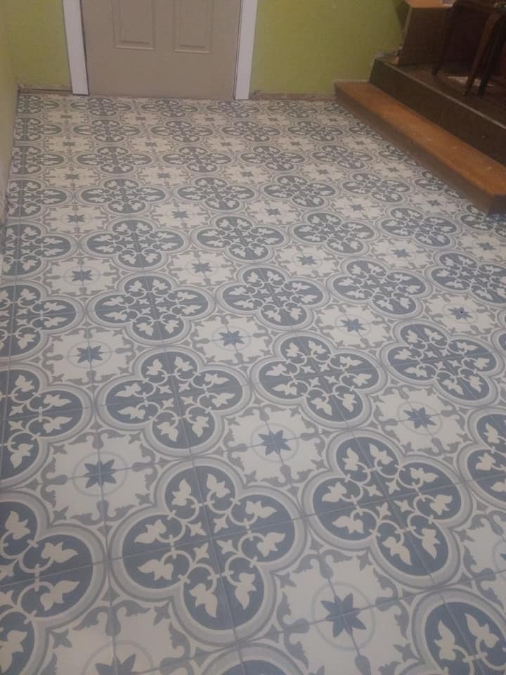 a tiled floor with a blue and white pattern in a room 