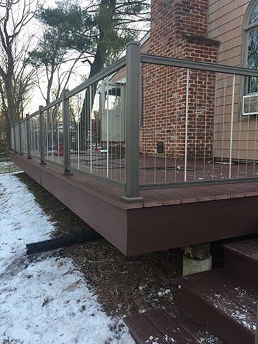 This Is An Azek Deck With Plugs Covering All Screws For A Smooth Deck Surface And A Aluminum Key Link — Decking Services in Wyncote, PA