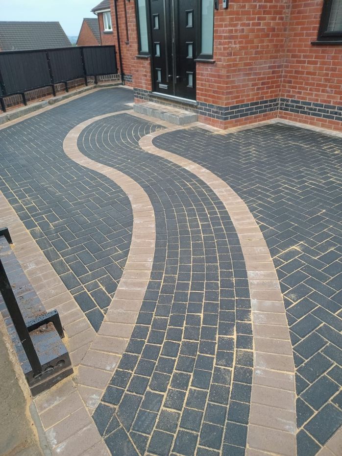 A modern house leading to a block paved driveway in Cambridge