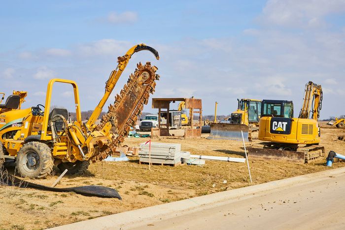 A construction site with a cat excavator in the foreground in Cambridge