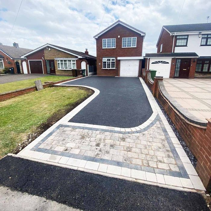 a house with a tarmac driveway and block paved edgings