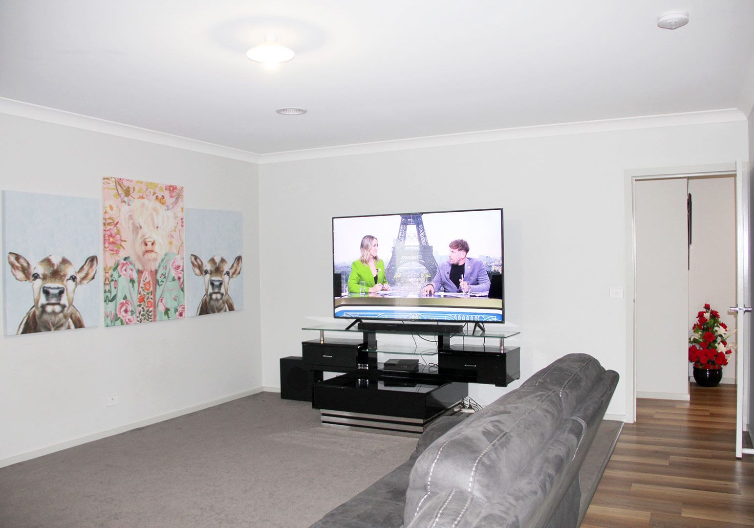 A Living Room With A Couch, Television , And Paintings On The Wall — GPM Care Services In Warrnambool, VIC