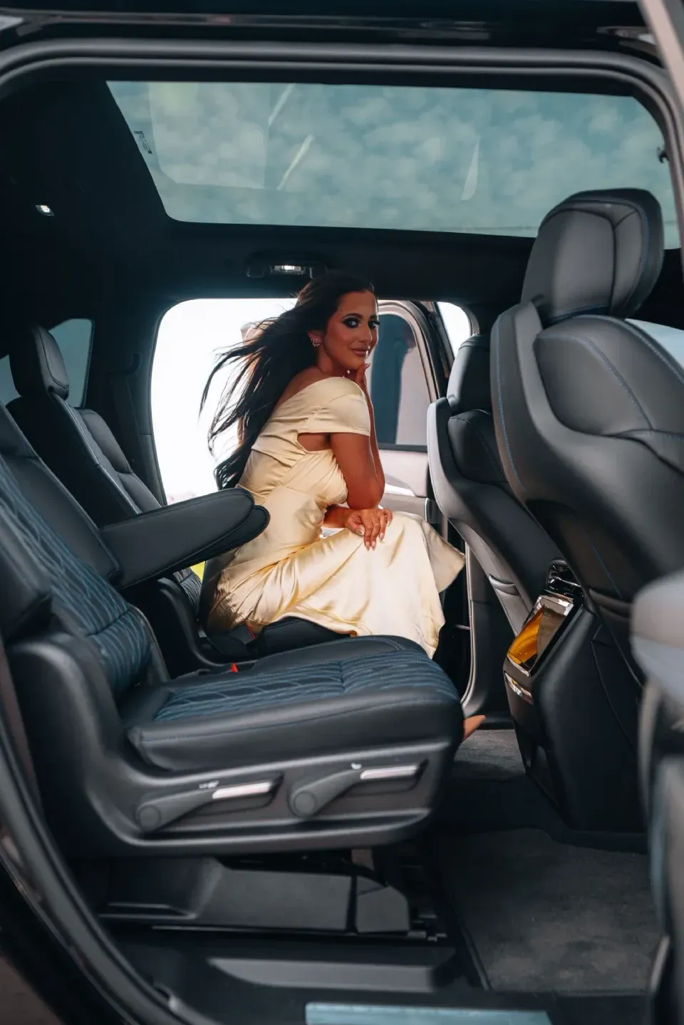 Guest seated in the back of a Cadillac Escalade IQ