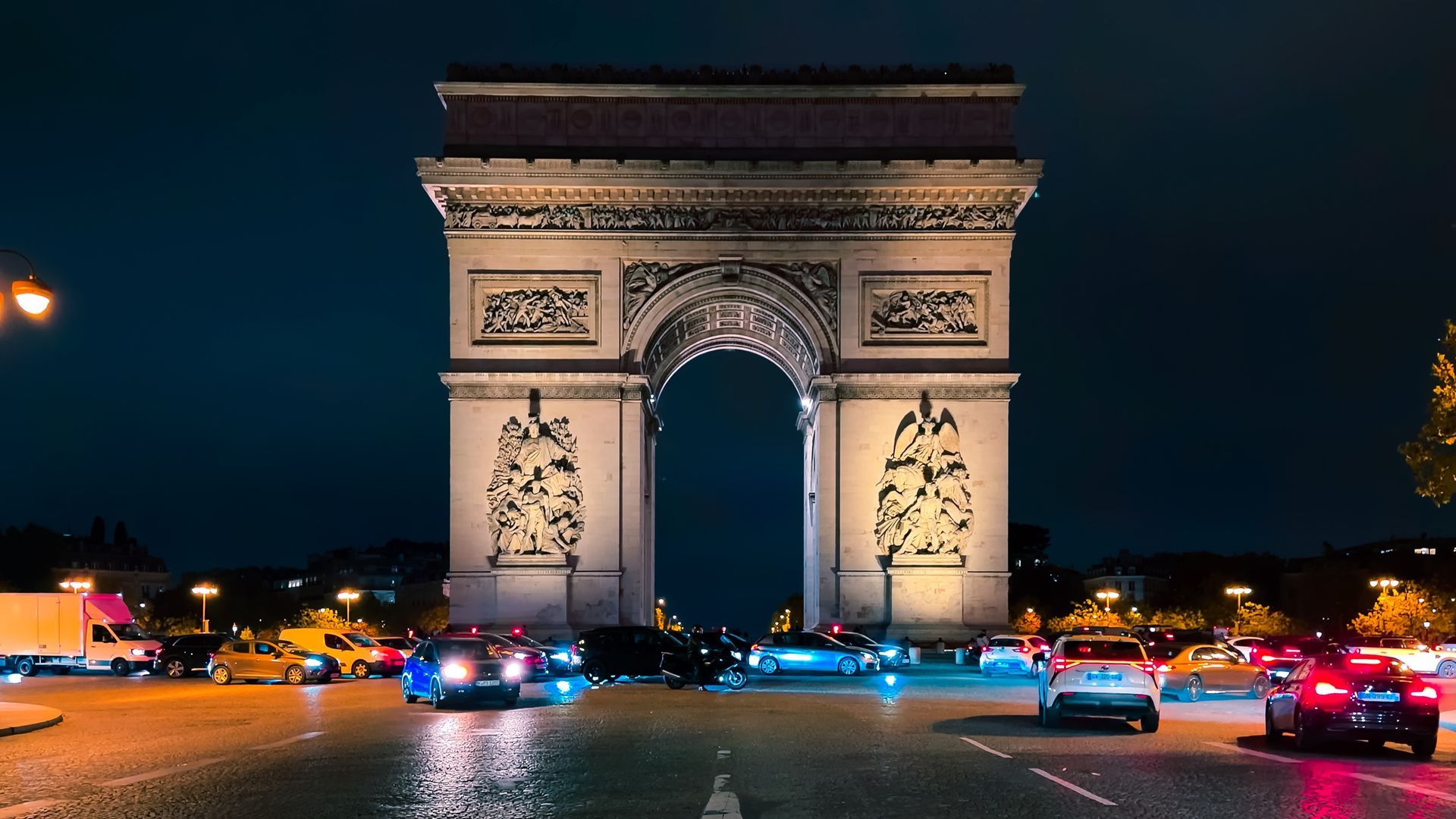 Modern skyscrapers rise above a green park under a bright blue, partly cloudy sky in downtown Houston.