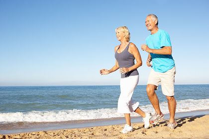 Senior couple jogging on beach and getting plenty of fresh air