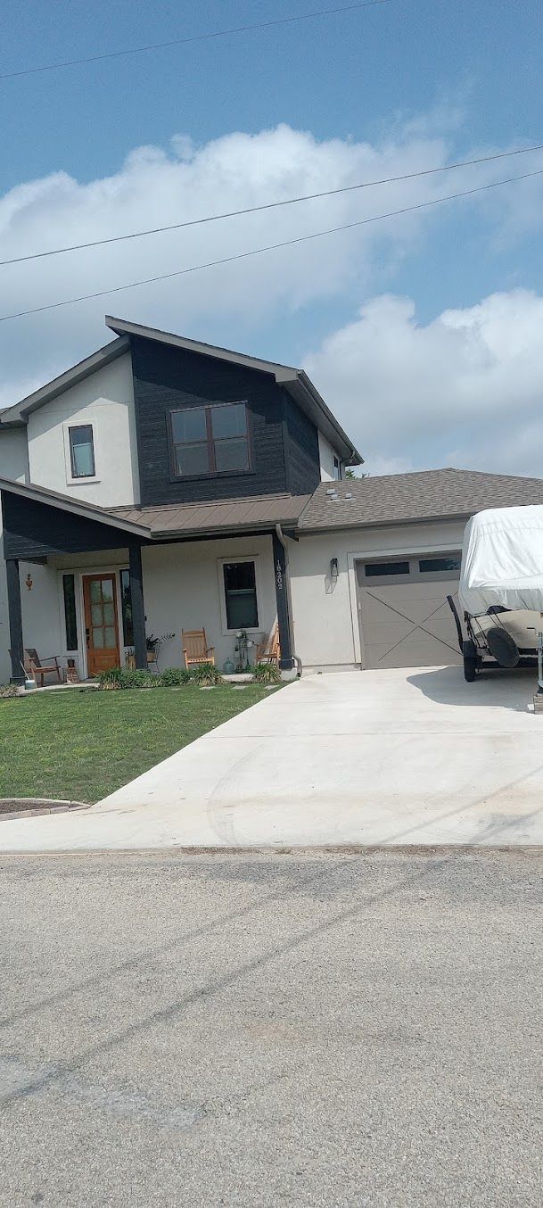 A house with a truck parked in front of it on a sunny day.