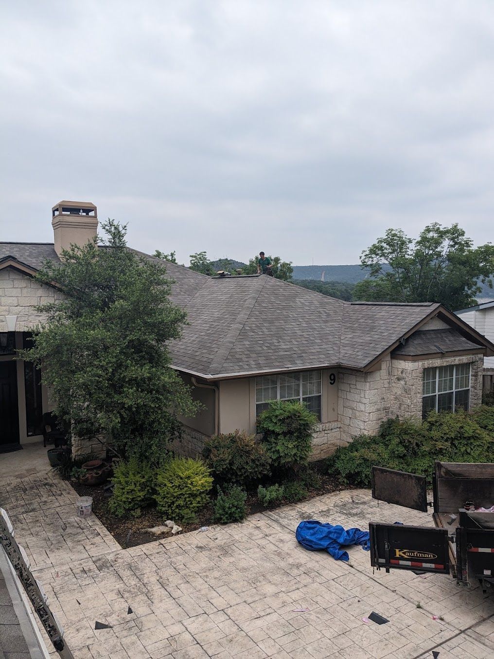 An aerial view of a large house with a gray roof.