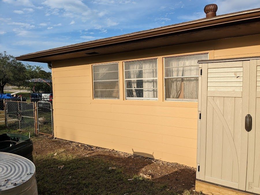 A small house with a garage and a lot of windows.