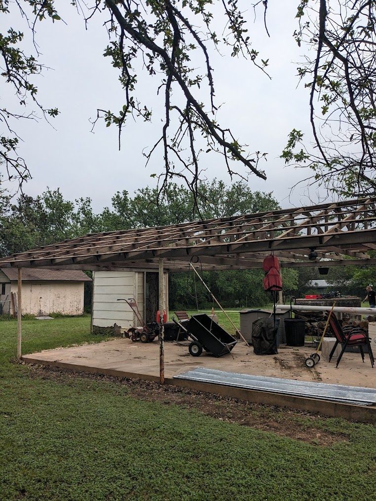 There is a shed in the middle of a grassy field.