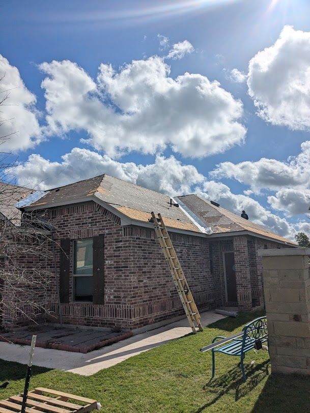 A brick house with a ladder attached to the side of it.