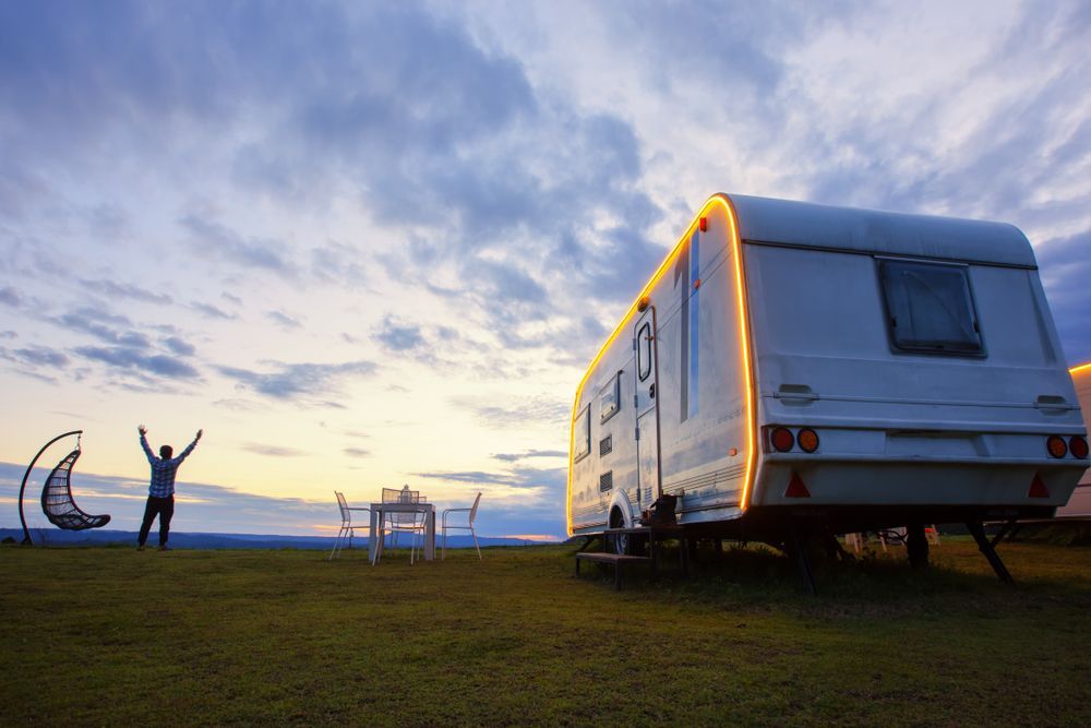 A Man And A Caravan With A Background Of Blue Sky — Kingston Caravan Repairs In Singleton, NSW