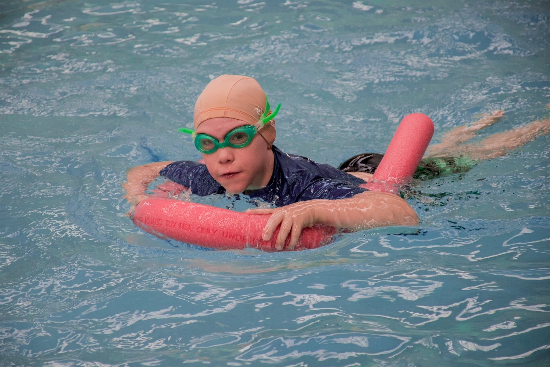 Kid on a Pool Noodle — Swim School in Barney Point, QLD