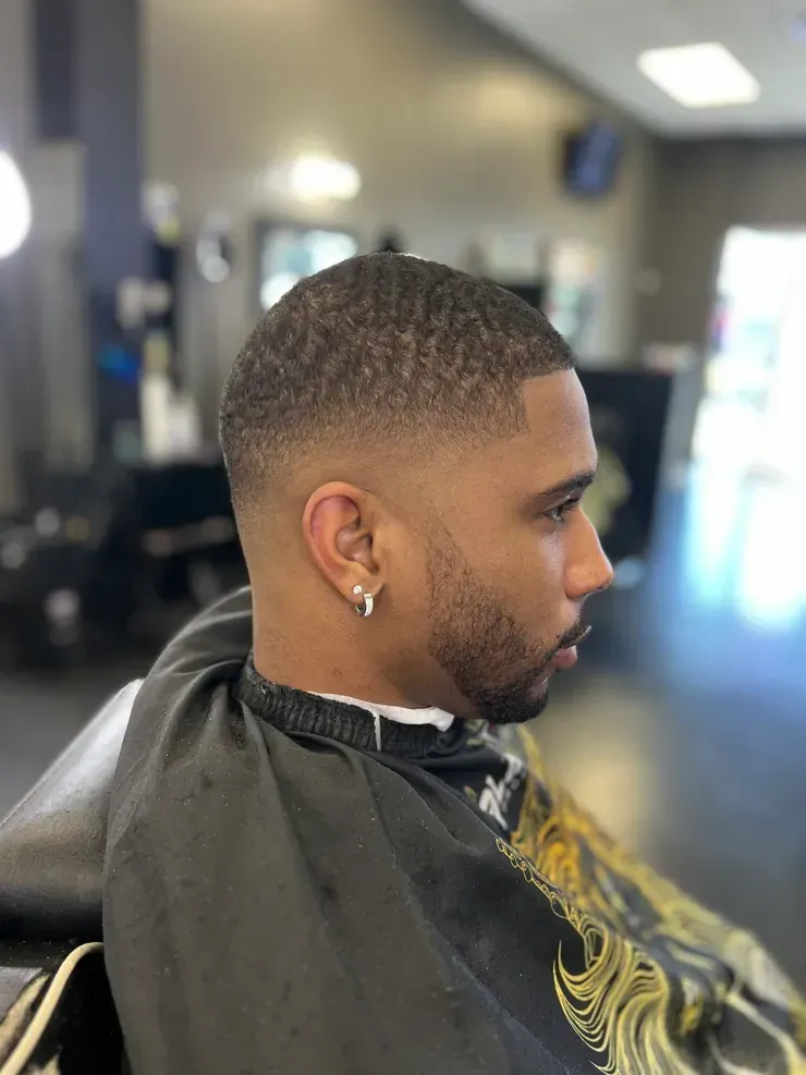 Bluue Images Barbers - A man is getting his hair cut at a barber shop in Snellville, GA.