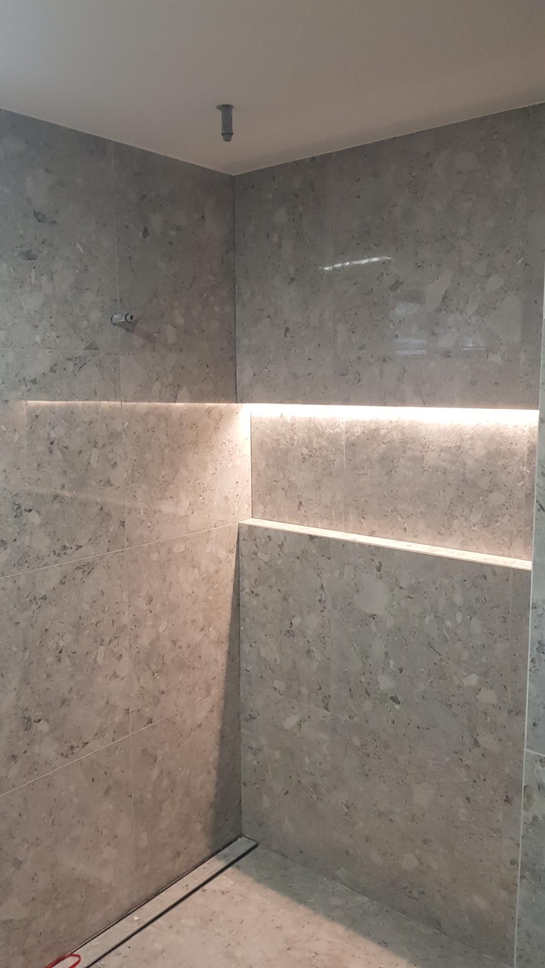 A Bathroom With A Shower And A Shelf In The Wall — AH Electrical in West Ballina, NSW