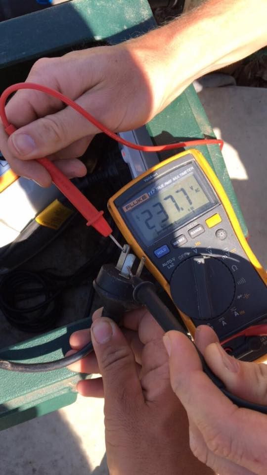 A Person is Using a Fluke Multimeter to Measure Voltage — AH Electrical in West Ballina, NSW