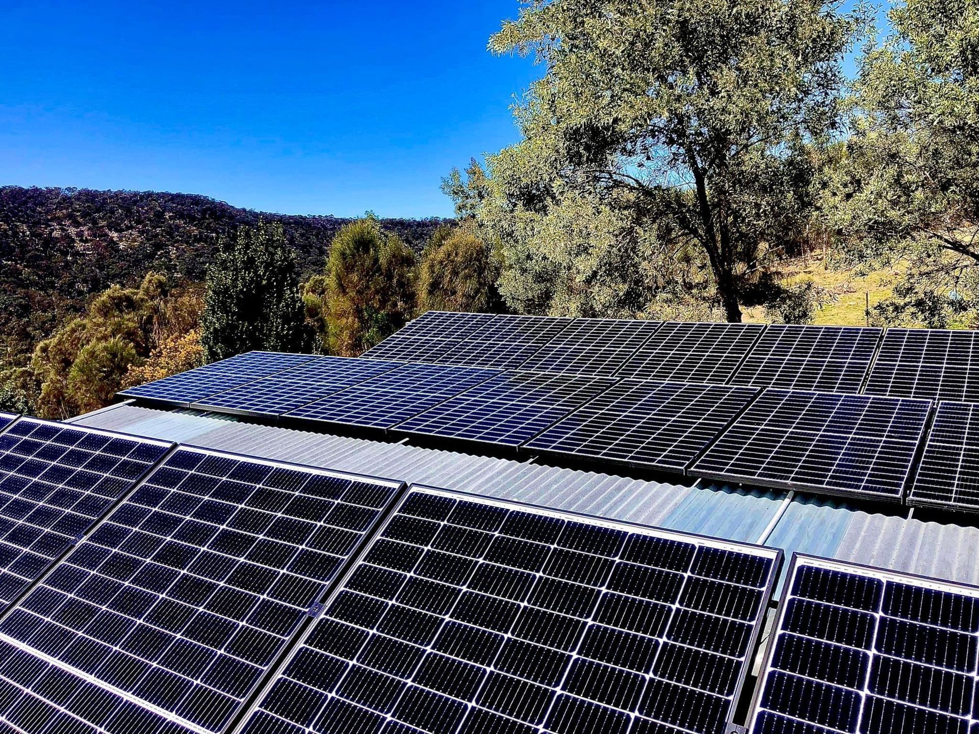 An Aerial View Of A House With Solar Panels On The Roof And A Truck Parked In Front Of It — AH Electrical in West Ballina, NSW