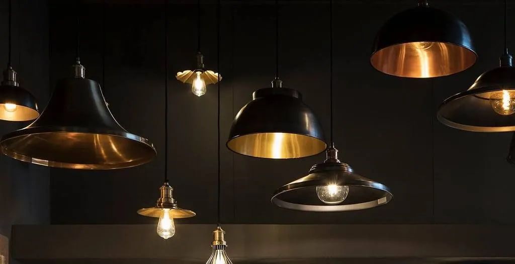 A gRoup of Pendant Lights Hanging From the Ceiling in a Dark Room — AH Electrical in Kyogle, NSW