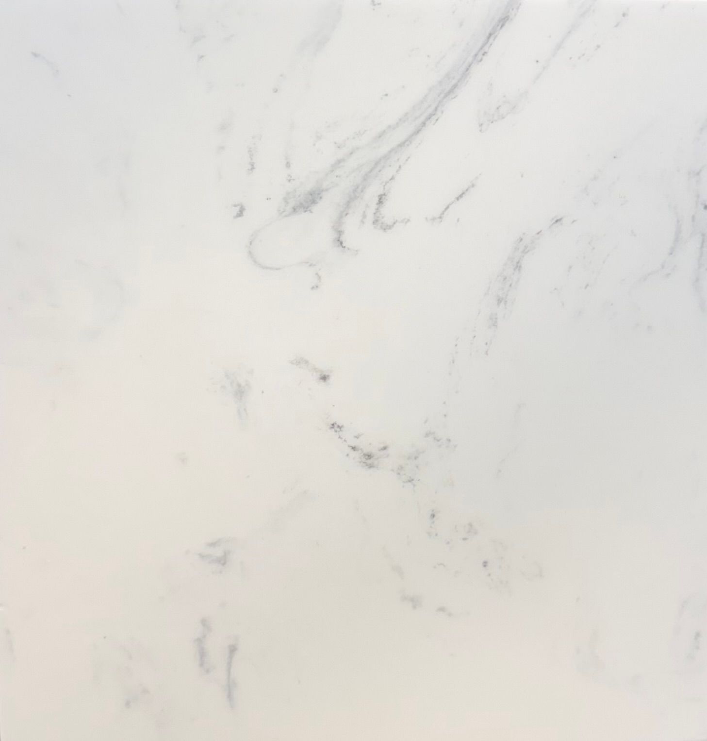 A texture of white marble stone with subtle grey veining running diagonally across the surface.