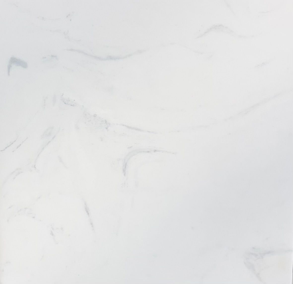 A texture of white marble stone with subtle grey veining running diagonally across the surface.